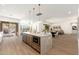 Open-concept kitchen boasts a large island, stainless appliances, and seamless flow to the living area at 11267 E Beck Ln, Scottsdale, AZ 85255