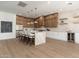 Modern kitchen island bar with pendant lights, updated stainless appliances and sleek countertops at 11267 E Beck Ln, Scottsdale, AZ 85255