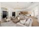 Spacious living area with views into the kitchen, bar, and dining area, decorated with comfortable seating and neutral tones at 11267 E Beck Ln, Scottsdale, AZ 85255