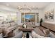 Elegant living room features a large window with views of the pool and a neutral color palette for a serene feel at 11267 E Beck Ln, Scottsdale, AZ 85255