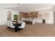Open concept dining and kitchen space with a modern dining table and chairs and an island bar for casual dining at 11267 E Beck Ln, Scottsdale, AZ 85255