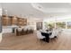 Open concept living space with a modern kitchen, dining area, and living room with an abundance of natural light at 11267 E Beck Ln, Scottsdale, AZ 85255