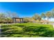 Serene park area featuring a lush lawn, shaded pergola with seating, and mature trees for tranquil outdoor enjoyment at 11267 E Beck Ln, Scottsdale, AZ 85255