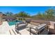 Outdoor seating and patio near a pool area and desert landscape, perfect for entertaining and relaxing at 11267 E Beck Ln, Scottsdale, AZ 85255
