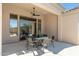 Covered patio with an outdoor dining set, stone pavers and views of the desert landscape at 11267 E Beck Ln, Scottsdale, AZ 85255
