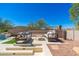 Outdoor living space with patio seating, a desert landscape view, and an adjacent swimming pool at 11267 E Beck Ln, Scottsdale, AZ 85255