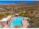 Aerial view of a pool, lounge chairs, and desert landscape with a backdrop of scenic mountains at 11267 E Beck Ln, Scottsdale, AZ 85255
