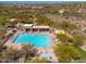 Aerial view of a community pool and jacuzzi surrounded by desert foliage and lounge chairs at 11267 E Beck Ln, Scottsdale, AZ 85255