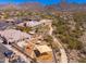 Aerial view of the community school, showing the playground, sports field, and picturesque desert setting at 11267 E Beck Ln, Scottsdale, AZ 85255