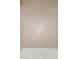 Detailed view of the shower wall with neutral patterned tiling and a gold shower head at 11267 E Beck Ln, Scottsdale, AZ 85255