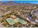 Aerial view of community tennis courts and pool area with desert landscaping and mountain views at 11267 E Beck Ln, Scottsdale, AZ 85255