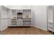 Custom walk-in closet with built-in shelving, drawers, and hanging rods at 11267 E Beck Ln, Scottsdale, AZ 85255