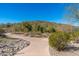 A winding walking path meanders through the desert landscape of this beautiful community at 11267 E Beck Ln, Scottsdale, AZ 85255