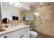 Bathroom featuring a glass-enclosed shower, tiled walls, modern vanity, and neutral-toned fixtures at 1173 E Beryl Ave, Phoenix, AZ 85020