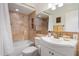 Bright bathroom with a shower-tub combo, decorative mirror and modern vanity with storage space at 1173 E Beryl Ave, Phoenix, AZ 85020