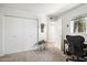Bright bedroom showcases ample closet space, a workstation, and neutral-toned carpet at 1173 E Beryl Ave, Phoenix, AZ 85020