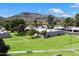 Beautiful community with lush green lawns and mature trees, set against a stunning mountain backdrop at 1173 E Beryl Ave, Phoenix, AZ 85020