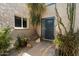 Cozy home entrance with desert landscaping, a secure screen door, and a tiled walkway at 1173 E Beryl Ave, Phoenix, AZ 85020