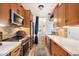 Modern galley kitchen with stainless steel appliances, subway tile backsplash, and ample counter space at 1173 E Beryl Ave, Phoenix, AZ 85020