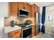 Modern kitchen features stainless steel appliances, a mosaic backsplash, and sleek countertops, with wooden cabinets at 1173 E Beryl Ave, Phoenix, AZ 85020