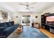Bright living room with hardwood floors, a plush sofa, and sliding glass doors to the patio at 1173 E Beryl Ave, Phoenix, AZ 85020