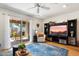 Comfortable living room boasts hardwood floors, sliding glass doors, and modern entertainment center at 1173 E Beryl Ave, Phoenix, AZ 85020