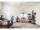 Home office with a ceiling fan, comfortable seating area, shelving, and ample natural light at 1173 E Beryl Ave, Phoenix, AZ 85020