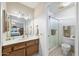Bathroom with a vanity with a sink, mirror, and a shower area with a glass door at 1202 Leisure World --, Mesa, AZ 85206