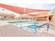 Community pool and shade structure with lounge chairs, shade and accessible entry points at 1202 Leisure World --, Mesa, AZ 85206