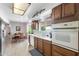 Cozy kitchen featuring white appliances, wood cabinetry, and a dining area for casual meals at 1202 Leisure World --, Mesa, AZ 85206