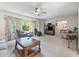 Bright living room with comfortable seating, ceiling fan, and natural light from large window at 1202 Leisure World --, Mesa, AZ 85206