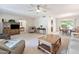 Spacious living room with neutral tones, a ceiling fan, and access to dining and sitting areas at 1202 Leisure World --, Mesa, AZ 85206