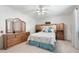 Comfortable main bedroom with ceiling fan and built-in headboard with mirrors at 1202 Leisure World --, Mesa, AZ 85206