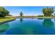 Scenic view of the tranquil pond with clear water, reflecting the surrounding trees and sky at 1202 Leisure World --, Mesa, AZ 85206