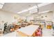 Well-lit workshop featuring various worktables, equipment, and organized tool storage at 1202 Leisure World --, Mesa, AZ 85206
