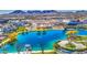 Stunning aerial view of the community lake, clubhouse and the surrounding neighborhood with mountain views at 1280 W Blue Ridge Dr, San Tan Valley, AZ 85140