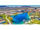 Community lake with a gorgeous clubhouse, lush landscaping, and scenic mountain views in this aerial shot at 1280 W Blue Ridge Dr, San Tan Valley, AZ 85140