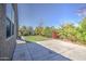 Wide shot of backyard with artificial grass, concrete patio, basketball hoop, and landscaping at 1280 W Blue Ridge Dr, San Tan Valley, AZ 85140