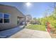 Backyard with artificial grass, landscaping, patio, and view of the back of the home at 1280 W Blue Ridge Dr, San Tan Valley, AZ 85140
