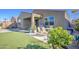 View of the backyard with artificial grass, patio, dining table and landscaping at 1280 W Blue Ridge Dr, San Tan Valley, AZ 85140