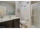 Bathroom featuring a dark vanity, toilet, glass shower, and nautical decor for a coastal touch at 1280 W Blue Ridge Dr, San Tan Valley, AZ 85140