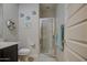 Bathroom with a glass shower, neutral walls, and charming nautical decor at 1280 W Blue Ridge Dr, San Tan Valley, AZ 85140
