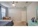 This bright bedroom includes a ceiling fan, side table, closet, and desk, perfect for a comfort at 1280 W Blue Ridge Dr, San Tan Valley, AZ 85140