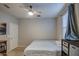 This bedroom has neutral walls, a ceiling fan, a window, and closet for storage at 1280 W Blue Ridge Dr, San Tan Valley, AZ 85140