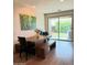 Bright dining area featuring a large wooden table, bench seating, and a view to the backyard at 1280 W Blue Ridge Dr, San Tan Valley, AZ 85140