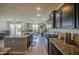 Open kitchen featuring granite countertops, stainless appliances, and seamless flow to the living area at 1280 W Blue Ridge Dr, San Tan Valley, AZ 85140