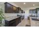 Open kitchen with stainless steel appliances and generous granite countertops and dark wood cabinetry at 1280 W Blue Ridge Dr, San Tan Valley, AZ 85140