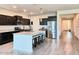 Bright, open kitchen with a granite island, stainless appliances, and dark cabinets at 1280 W Blue Ridge Dr, San Tan Valley, AZ 85140