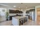 The open kitchen features a center island with granite counters and stainless steel appliances at 1280 W Blue Ridge Dr, San Tan Valley, AZ 85140