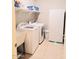 Updated laundry room features a washer, dryer, utility sink, shelving, and additional storage at 1280 W Blue Ridge Dr, San Tan Valley, AZ 85140